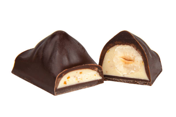 istock Chocolate sweet candy with nut glazed in half isolated on the white background 1400267944