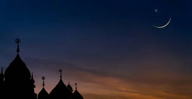 Mosques dome on dusk sunset sky and crescent moon symbol religion of Islamic free space text with Ramadan month, Eid Al Adha, Eid Ul Fitr, Muharram
