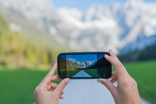 She takes photos of distant mountain range, from mountain road