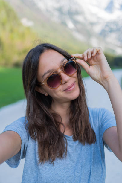istock Young woman relaxes on mountain road 1400271741