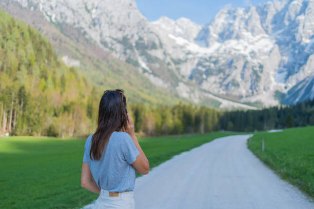 istock Young woman relaxes on mountain road 1400271788