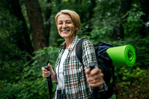 Mid adult woman in the forest hiking