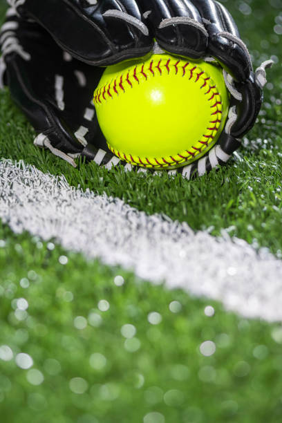 istock Selective focus on a yellow softball in a glove along the baseline – night game 1400274362