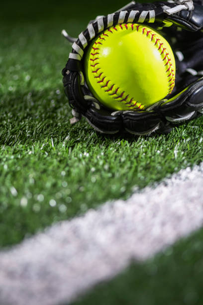 istock Selective focus on a yellow softball in a glove along the baseline – night game 1400275973