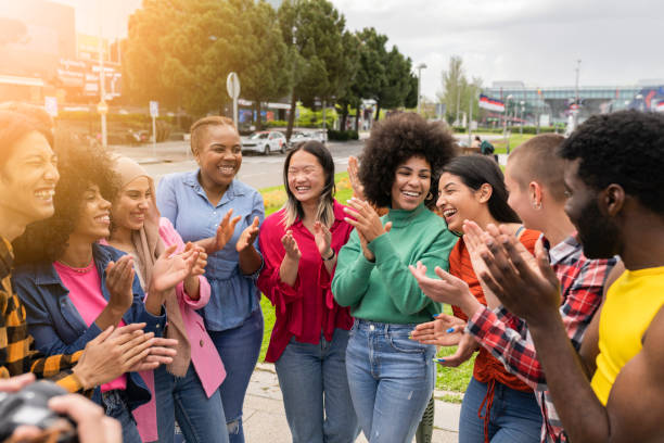istock Multiracial friends supporting team watching game together, clapping hands, diverse group at outdoor gathering happy 1400277116