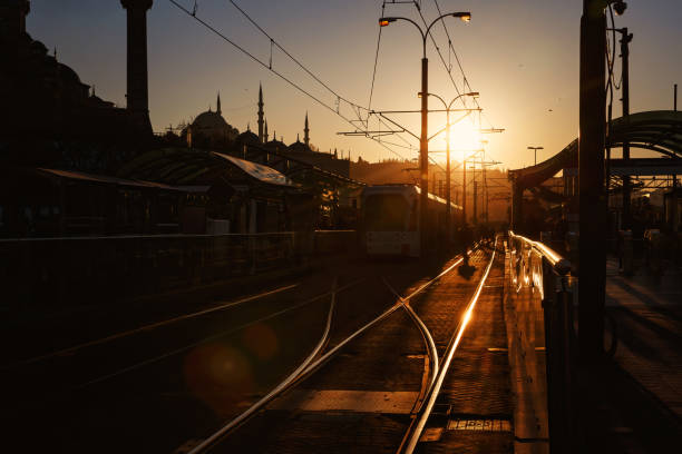 istock Public transport stop. Glare from the setting sun on the rails. 1400278658
