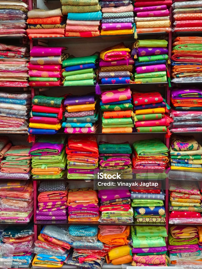 Fancy Indian sarees, Neatly stacked colorful silk saris in racks in a textile shop. Incredible India. Shopping Stock Photo