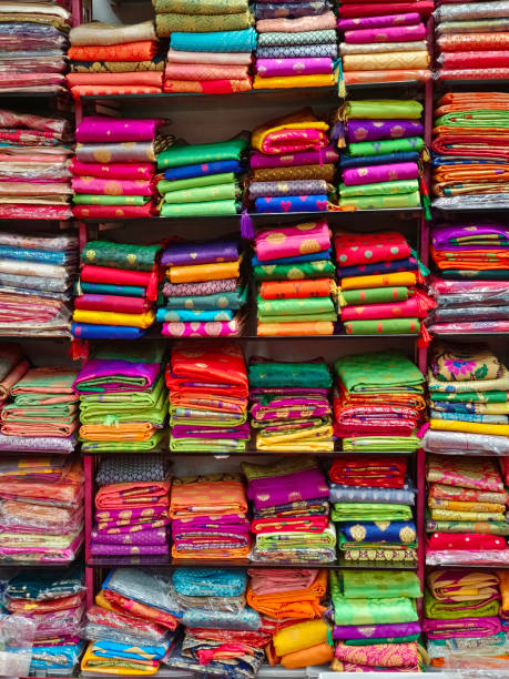 Fancy Indian sarees, Neatly stacked colorful silk saris in racks in a textile shop. Incredible India. Fancy Indian sarees, Neatly stacked colorful silk saris in racks in a textile shop. Incredible India. india indian culture market clothing stock pictures, royalty-free photos & images