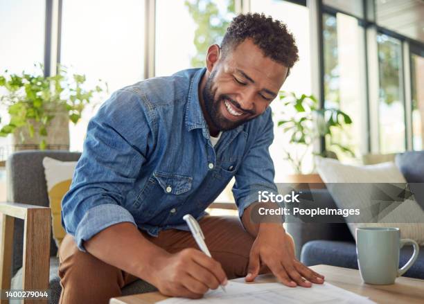Happy Bachelor Signing A Contract Man Filling Out Insurance Documents Handsome Young Man Filling Out Banking Papers Hispanic Young Man Filling Out Paperwork To Invest Insurance Stock Photo - Download Image Now