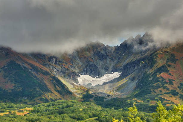 Vachkazhets volcano under clouds on Kamchatka peninsula\