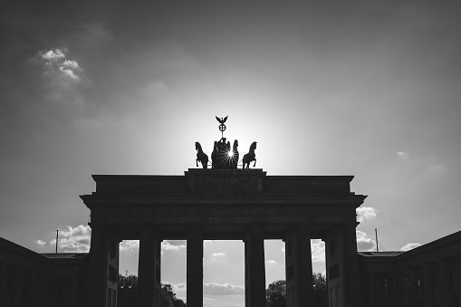 Monochrome closeup in starry sunshine of the top half of the world famous Brandenburg Gate in Berlin,Germany with copyspace.