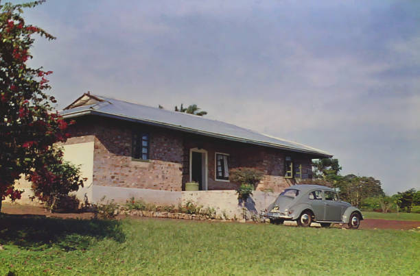 A rest house and grey car in the town of Abetifi in Ghana taken in 1959 stock photo