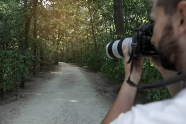istock Handsome man with camera spending time in nature reserve, closeup 1400284623