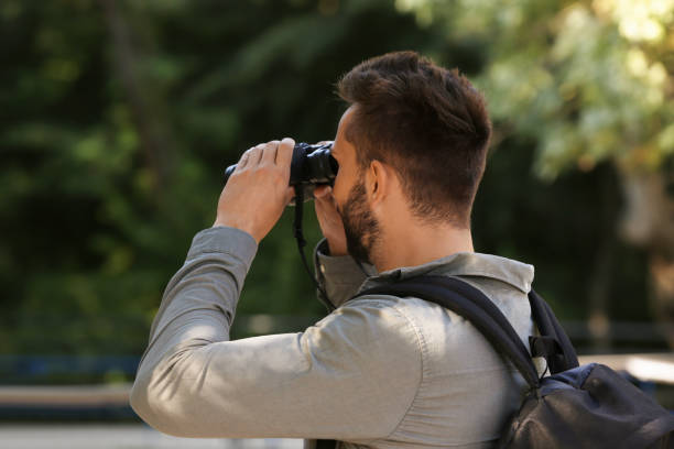 istock Handsome man with binoculars spending time in nature reserve 1400284646