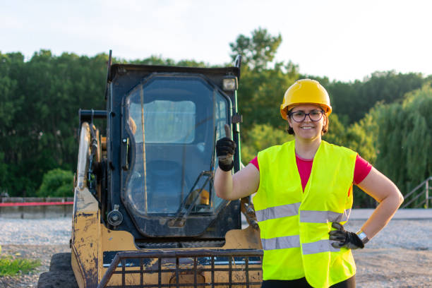 istock female construction worker in front of earth mover 1400285184