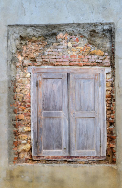 istock Old wooden window shutters and exposed brick wall revival process, beautiful backdrop for a model shoot. 1400286450