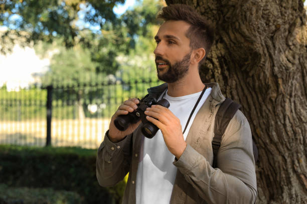 istock Handsome man with binoculars spending time in nature reserve 1400288059