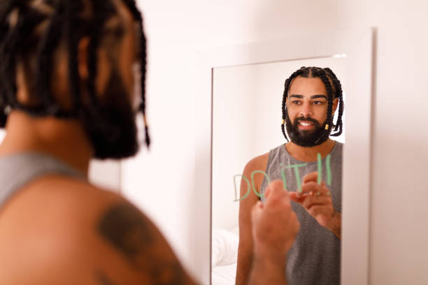 istock Man encouraging himself with message in the mirror 1400290459