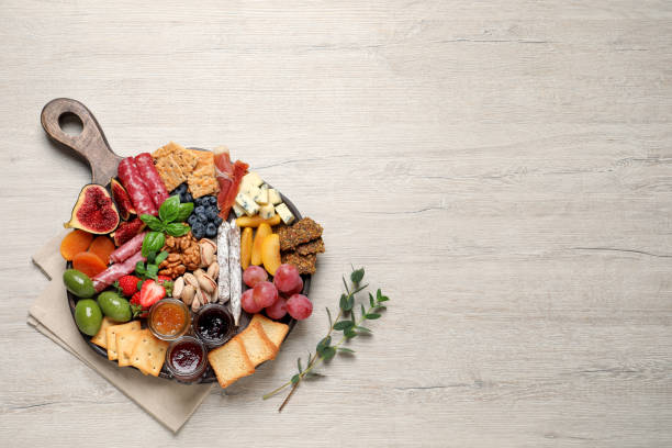 istock Different tasty appetizers on wooden table, flat lay. Space for text 1400290835