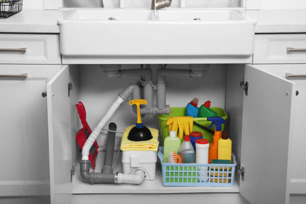 istock Open under sink cabinet with different cleaning supplies in kitchen 1400290836