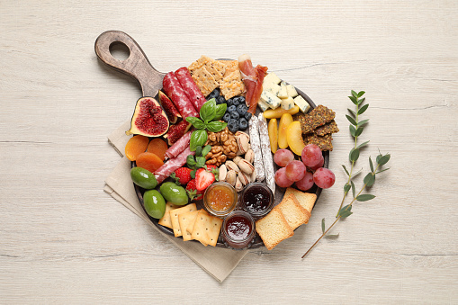 Different tasty appetizers on wooden table, flat lay