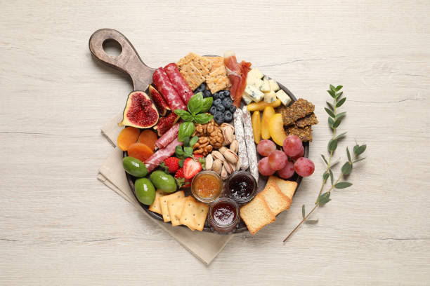 Different tasty appetizers on wooden table, flat lay Different tasty appetizers on wooden table, flat lay charcuterie stock pictures, royalty-free photos & images