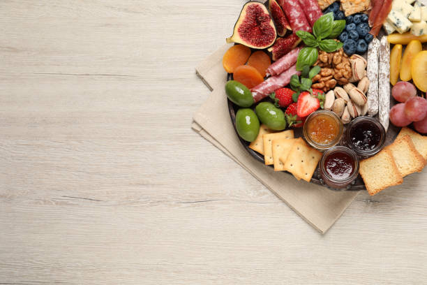 istock Different tasty appetizers on wooden table, top view. Space for text 1400291157