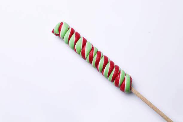 Sweet colorful lollipop on light background, top view