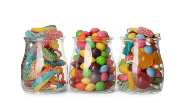 istock Glass jars with different candies on white background 1400291442