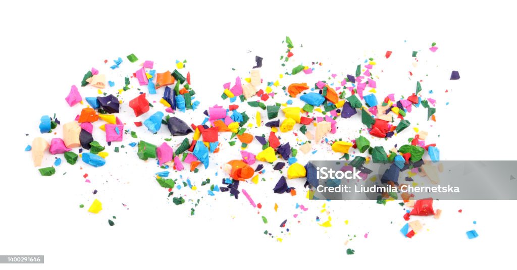 Colorful graphite crumbs on white background. Pencil sharpening Crayon Stock Photo