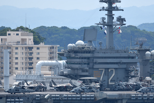 Kanagawa, Japan - June 01, 2022: United States Navy USS Abraham Lincoln (CVN-72), Nimitz-class aircraft carrier departing from Yokosuka Port.
