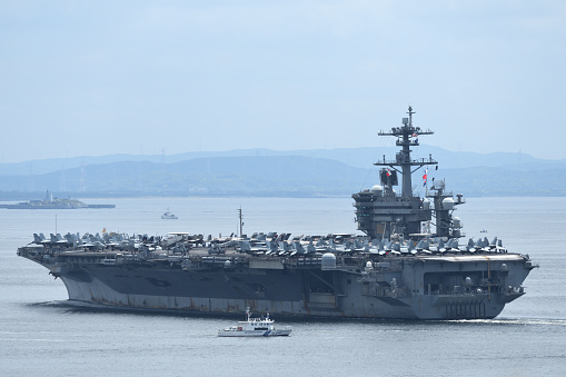 Nuclear War Ship, Military navy ship carrier full loading fighter jet aircraft for prepare troops. forwarder mast. Side view of War Ship.