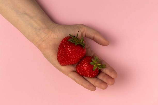 istock Strawberries in a woman's palm. 1400292919