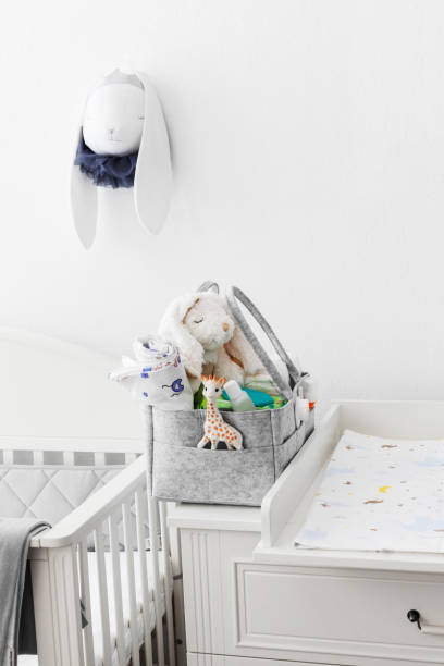 istock Mothers bag with toy and accessories on white background 1400292957