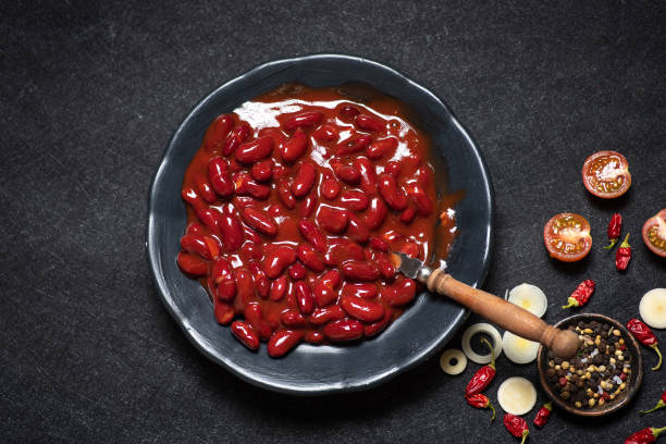 Red Mexican beans Red Mexican beans in a ceramic bowl on a rustic black-gray background kidney bean stock pictures, royalty-free photos & images