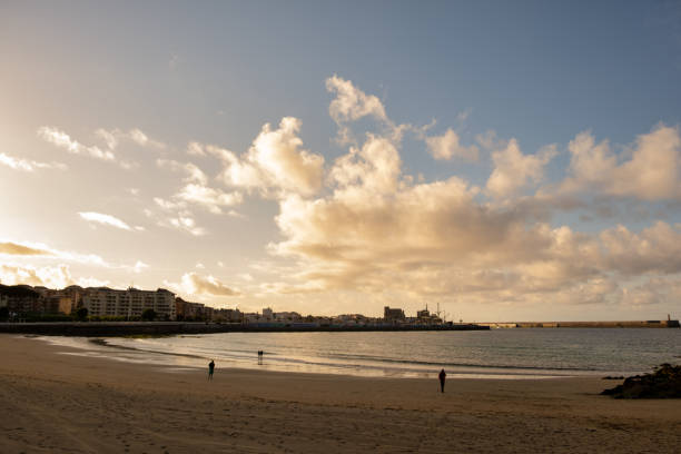 istock Unrecognizable  persons walks on the beach at sunset 1400294144