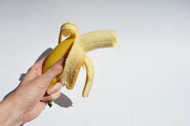 istock a bitten banana in a peel on a white background. ripe fruit. 1400295693