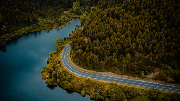 istock WINDING MOUNTAIN ROAD WITH LAKE FROM AERIAL VIEW WITH DRONE 1400296732