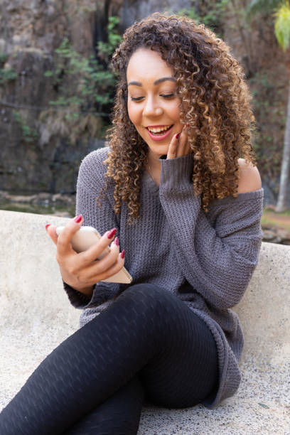 istock Young black woman using cell phone 1400297122