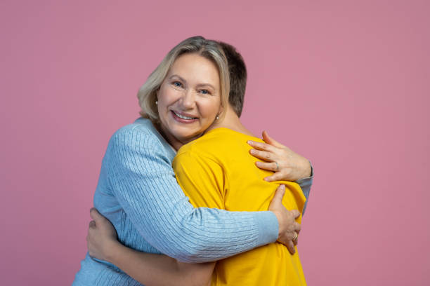 istock Happy woman hugging son smiling at camera 1400298862