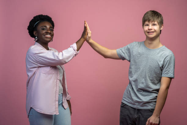 istock Woman and guy touching with palms looking at camera 1400298876