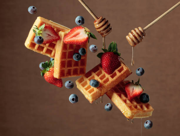 istock Waffles with fresh blueberries, strawberries, and honey. 1400299344