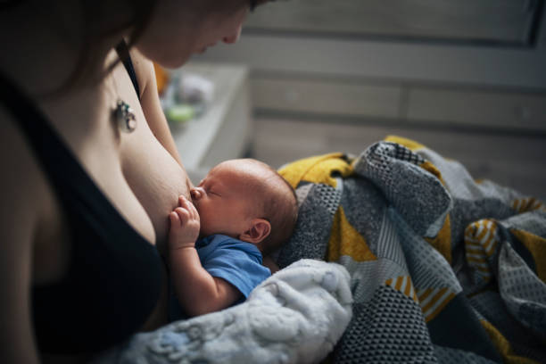 istock Mother breastfeeding baby son at home. 1400300253