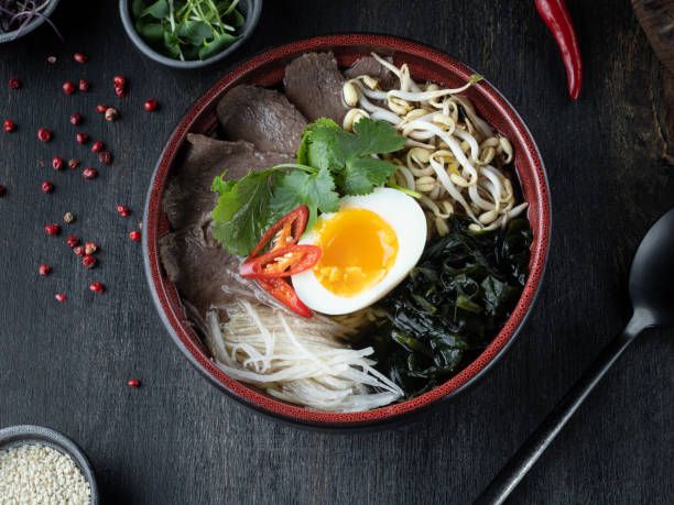 istock Pho Bo vietnamese Soup with beef on dark background. Top view 1400300355