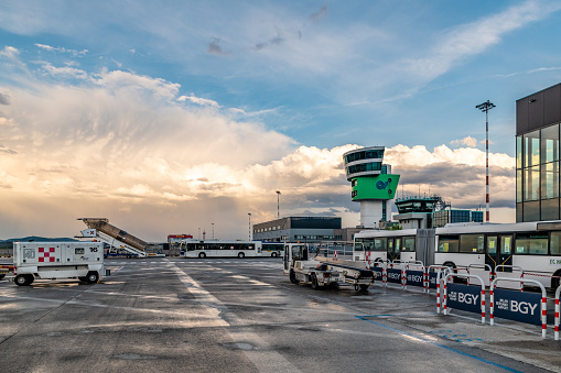 Bergamo, Italy. Tuesday 24 May 2022. Sunset and rain clouds at Bergamo Airport in Italy with ground crew.