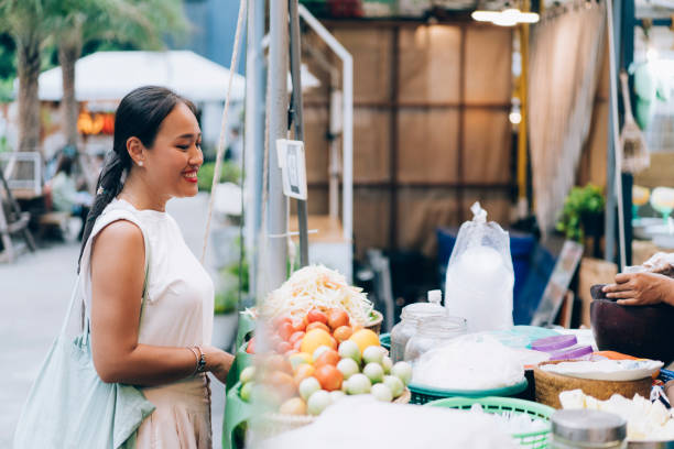istock Asian Woman Buying Fruit Salad 1400301559