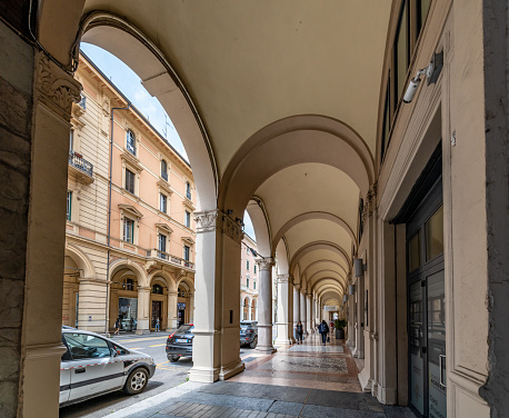 Bologna, Italy. Tuesday 24 May 2022. Portico covered walkways of Bologna, Italy with shops and restaurants