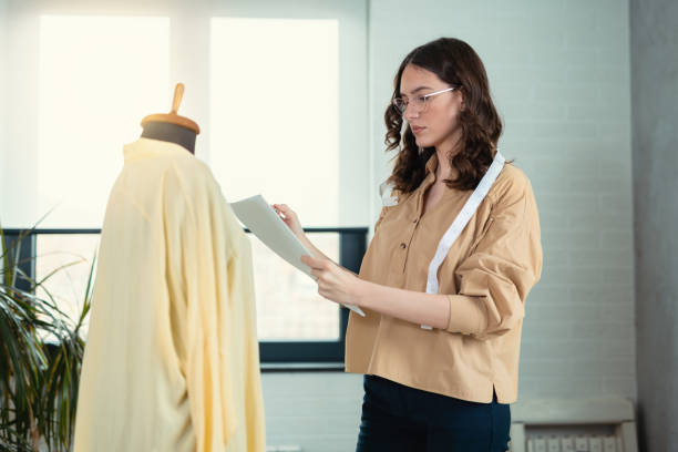 Young woman making clothes. Fashion designer. Tailor made stock photo
