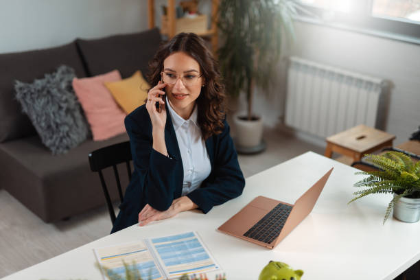 Business woman talking on phone. Businesswoman working from home and using phone stock photo