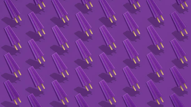 Trendy Summer pattern made with purple grape popsicle ice cream on purple background with clipping path. Minimal summer concept. stock photo